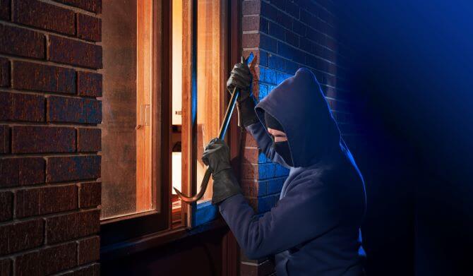 Burglar breaking into home